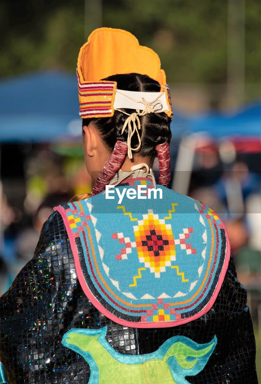 REAR VIEW OF WOMAN WITH MULTI COLORED HAT
