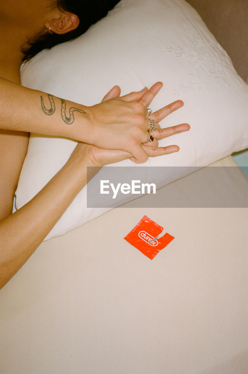 Woman lying on bed at home
