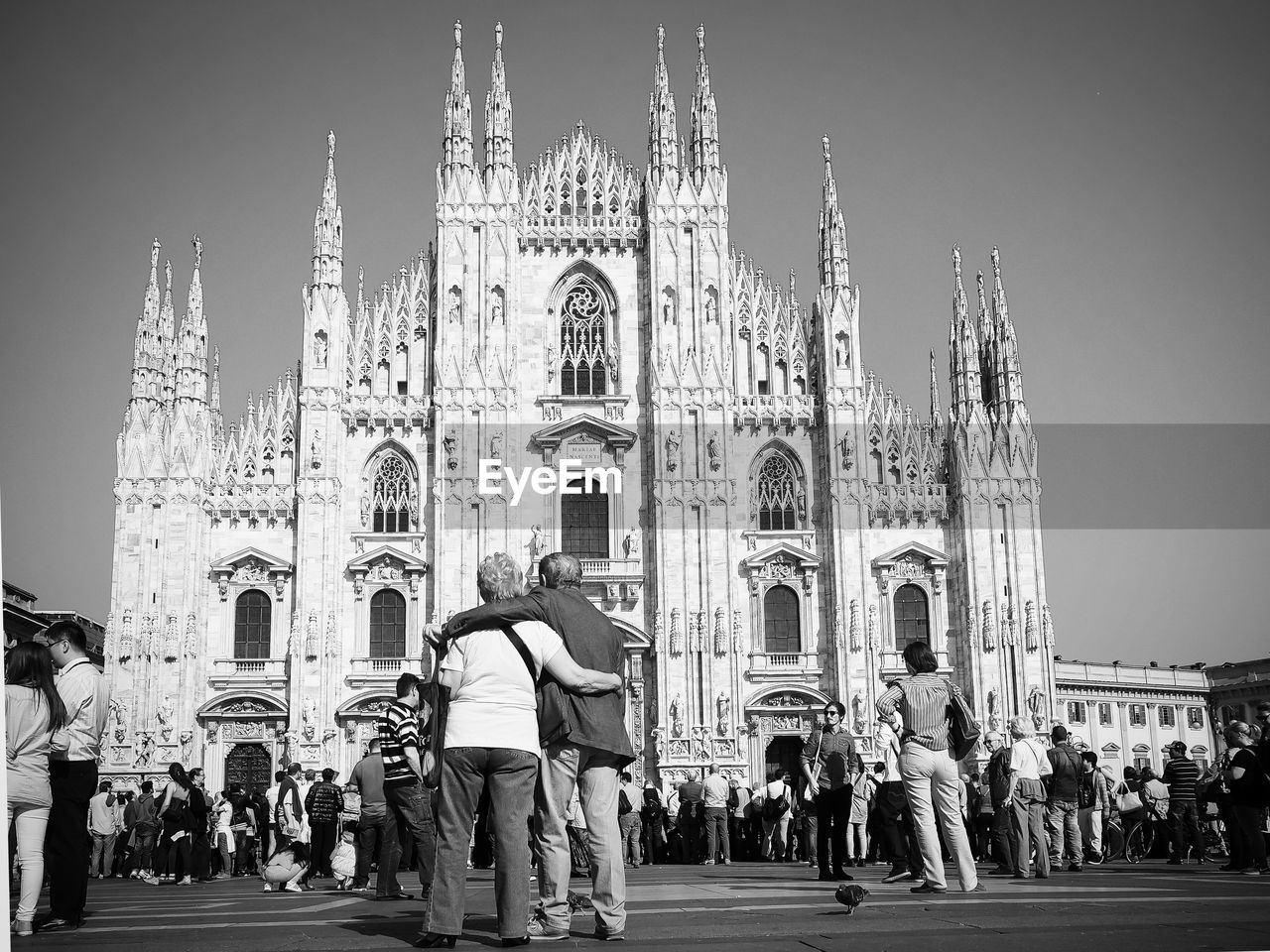 Tourists at milan cathedral against sky