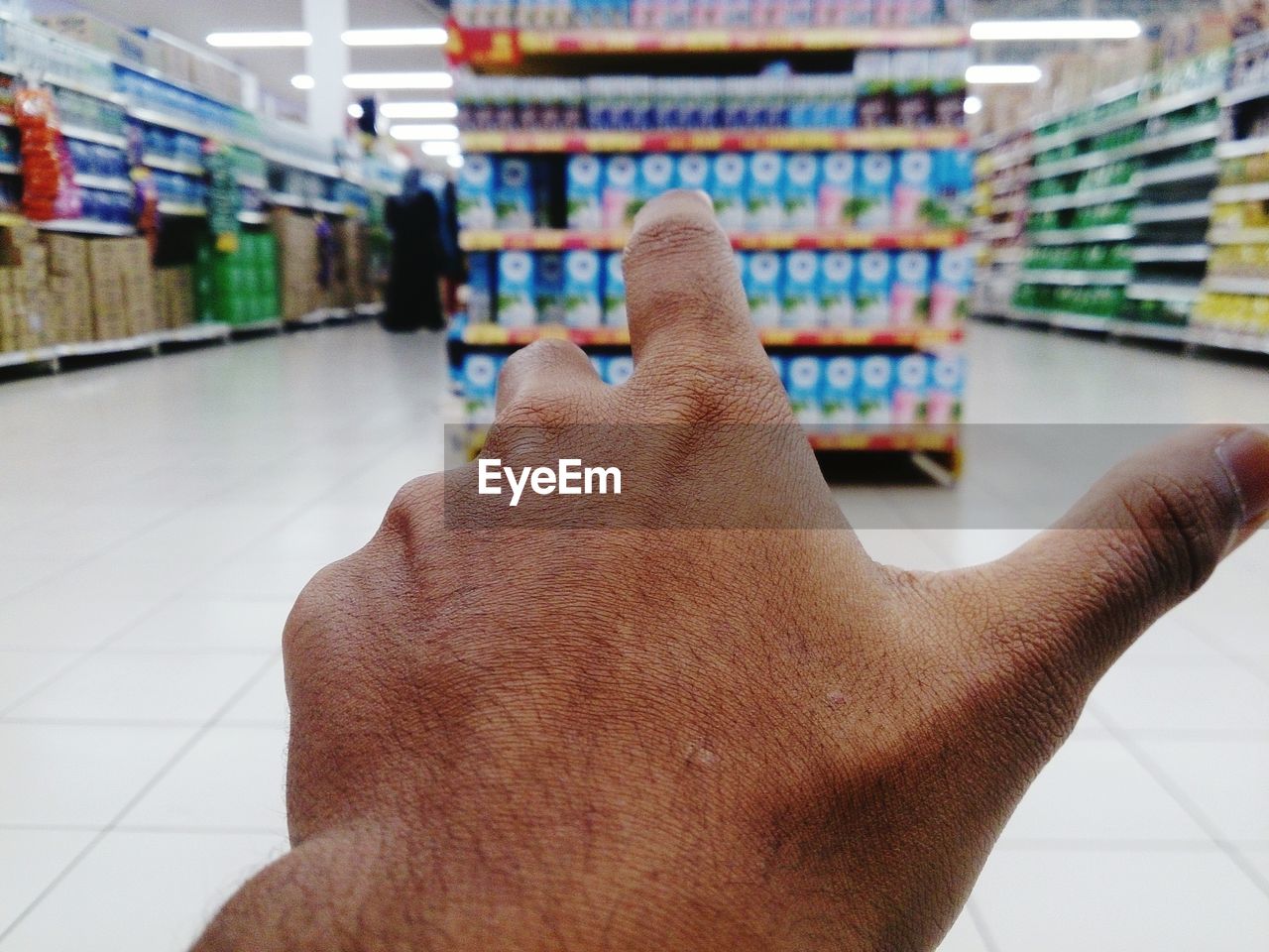 Cropped image of hand gesturing in supermarket