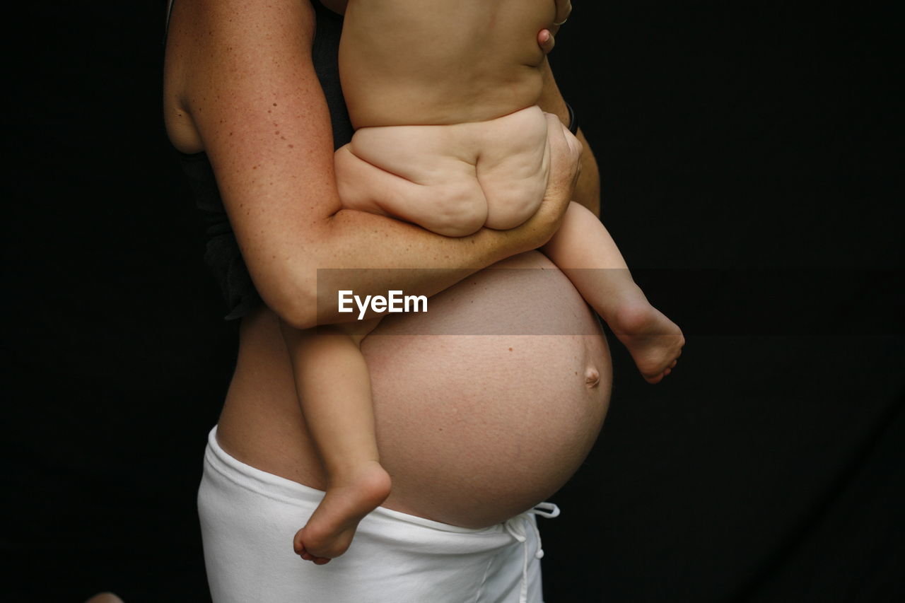 Pregnant Black Mom Nude - Midsection of pregnant mother with naked baby | on EyeEm