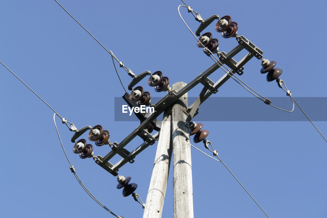 LOW ANGLE VIEW OF POWER LINES AGAINST CLEAR SKY