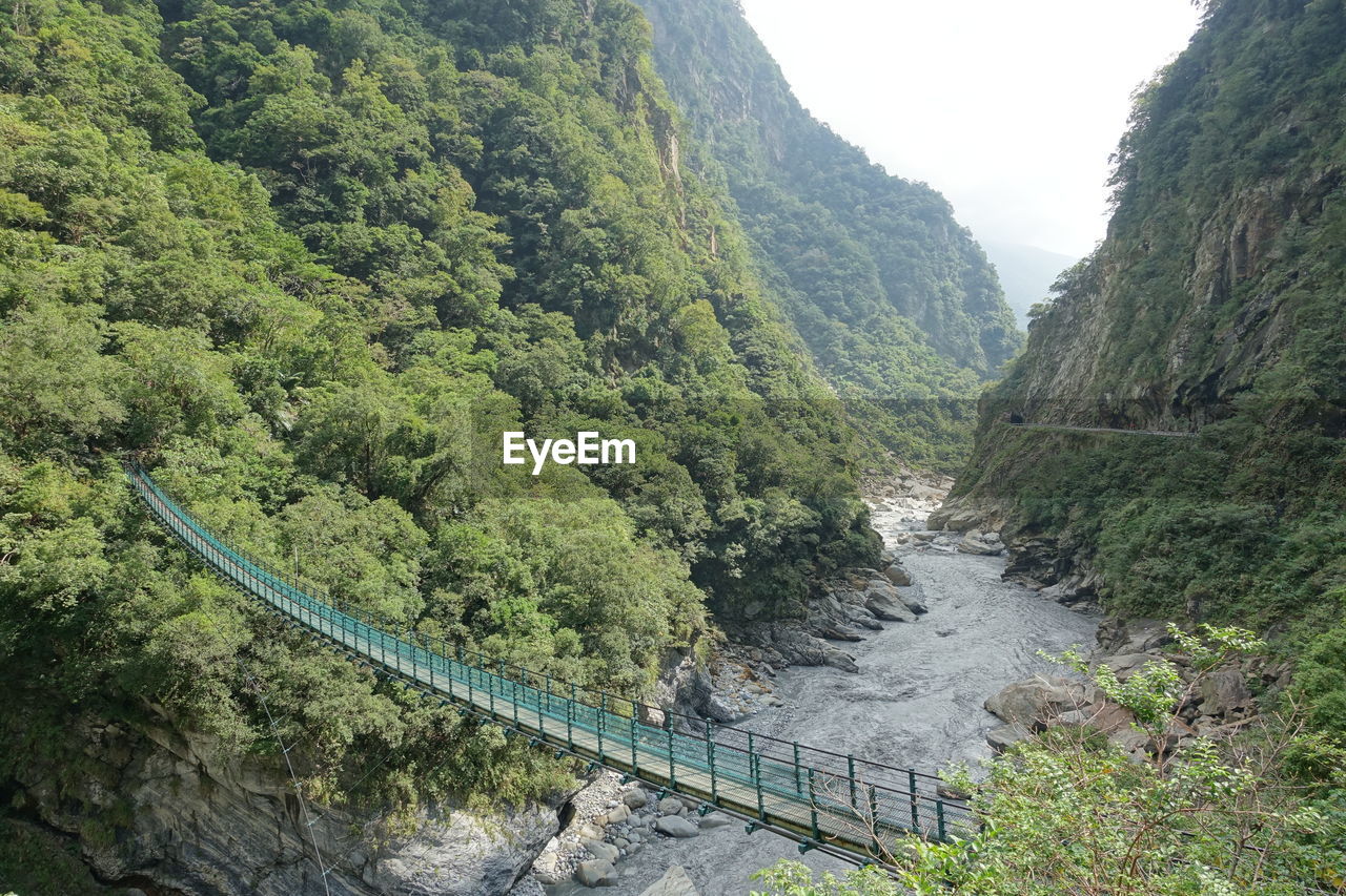 High angle view of waterfall amidst trees in forest