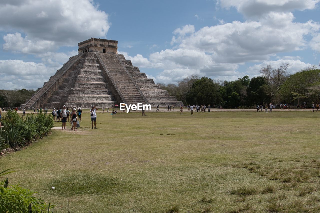 history, the past, architecture, travel destinations, travel, ancient, monument, tourism, built structure, cloud, ancient civilization, sky, archaeology, archaeological site, nature, pyramid, group of people, temple - building, landmark, tourist, old ruin, religion, plant, vacation, trip, ruins, large group of people, holiday, building exterior, ancient history, grass, belief, crowd, landscape, city, spirituality, rural area, outdoors, place of worship, tree, environment, memorial, old, leisure activity, lifestyles, day, land, adult, building, men