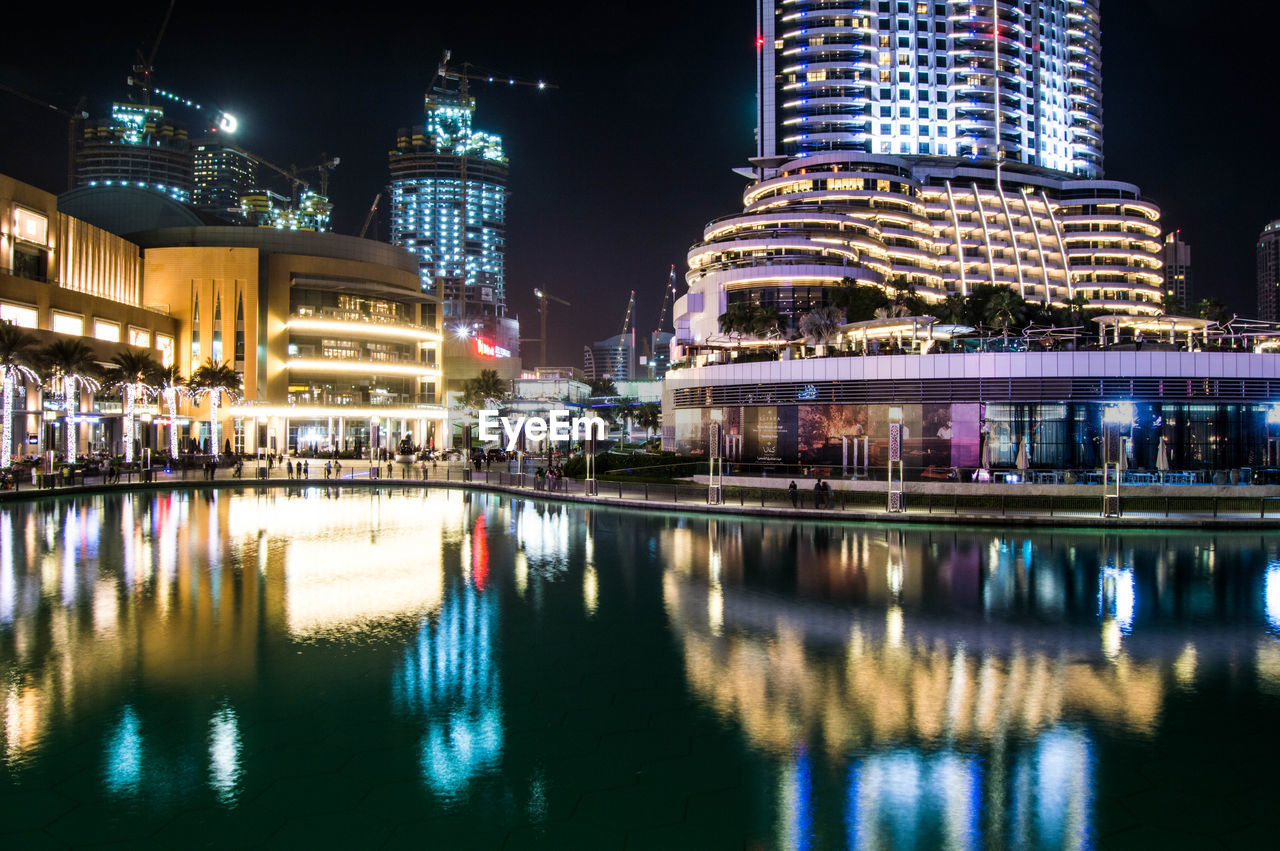 REFLECTION OF ILLUMINATED BUILDINGS IN WATER