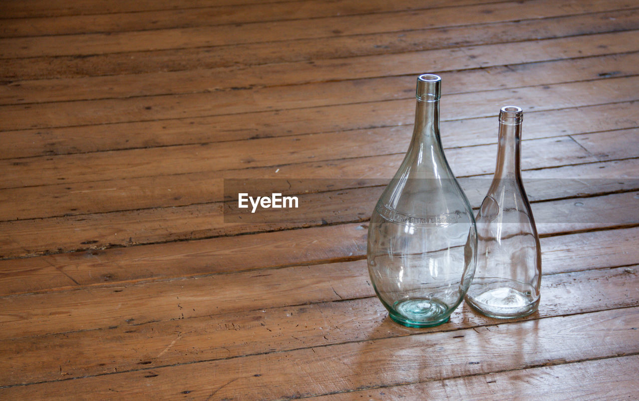 Glass bottles on hardwood floor