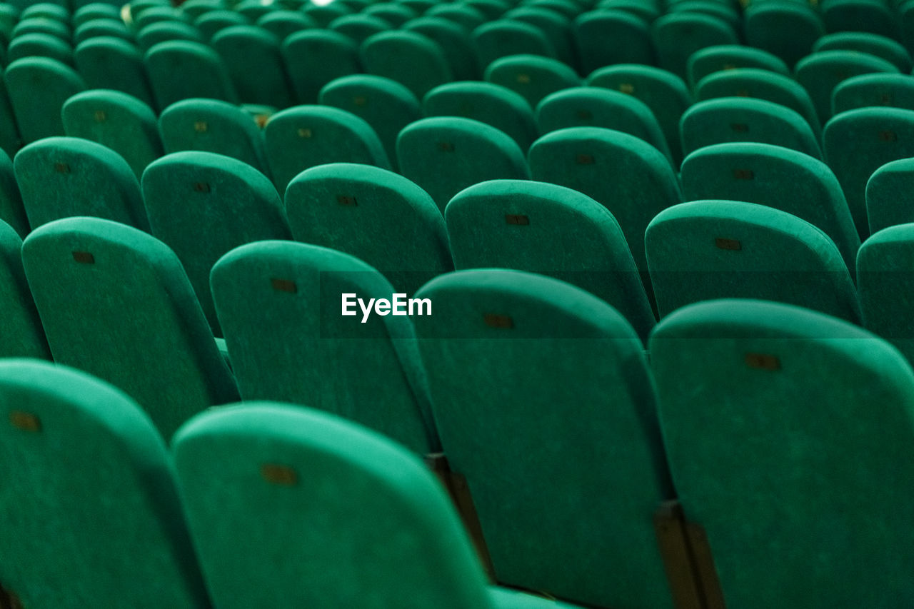 Classic rows of empty green seats in the theater. hall without visitors.