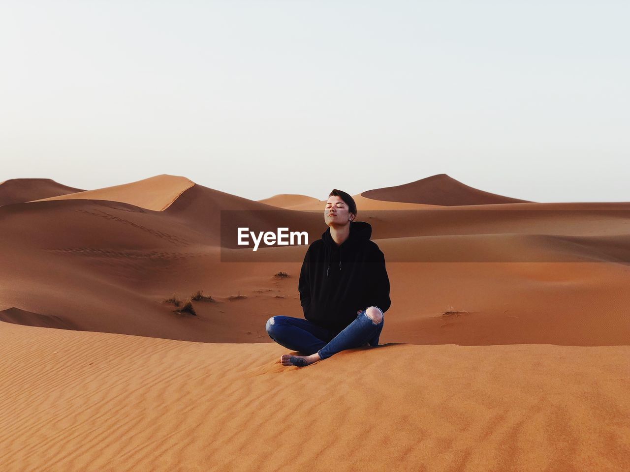 Woman sitting at desert