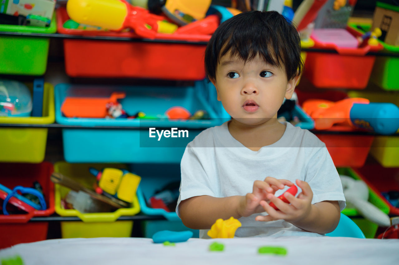 portrait of cute boy playing with toy blocks