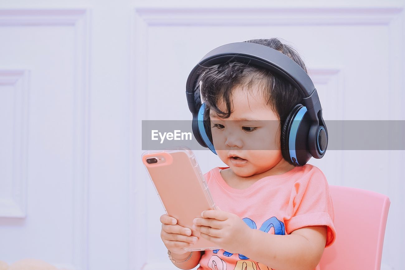 Baby Girl Listening Music While Using Id 142606076
