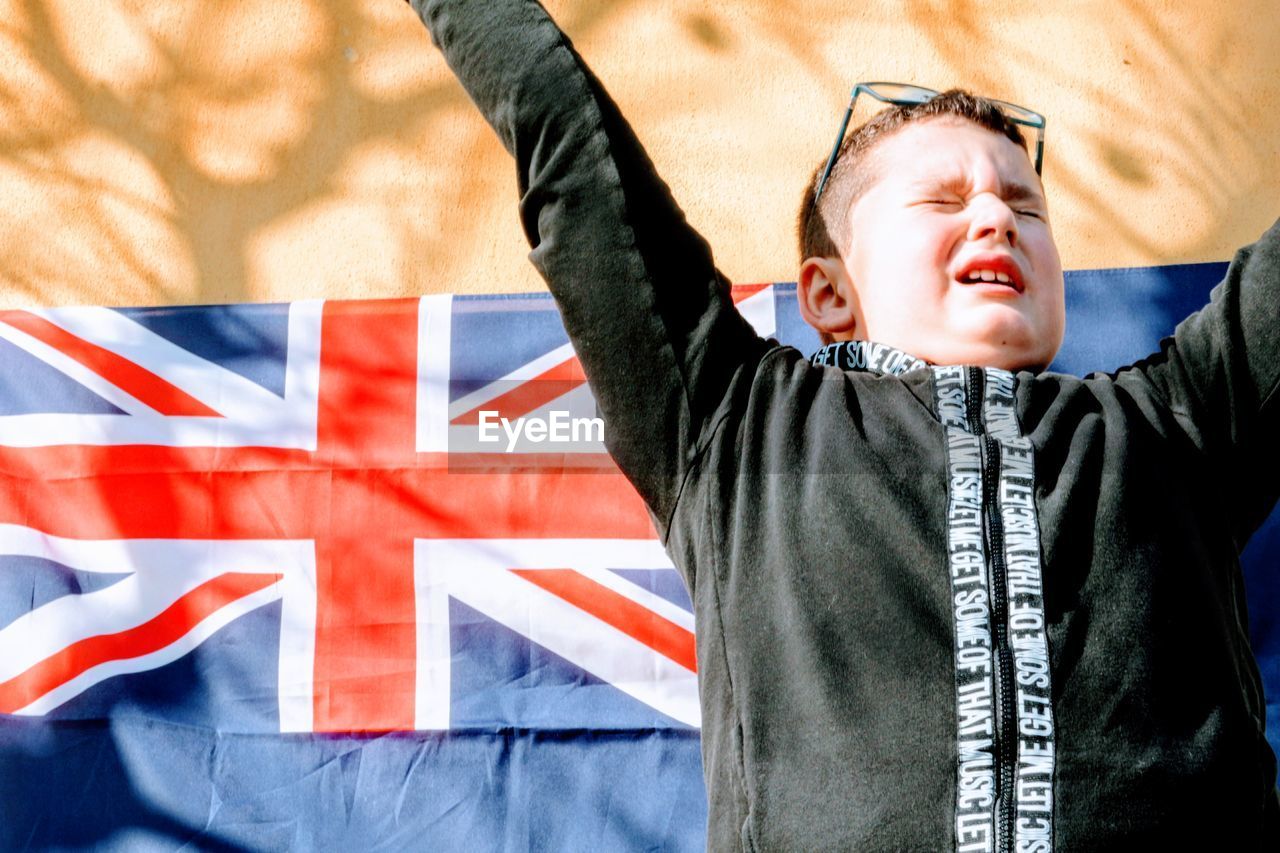 FULL LENGTH OF A BOY PLAYING WITH FLAG