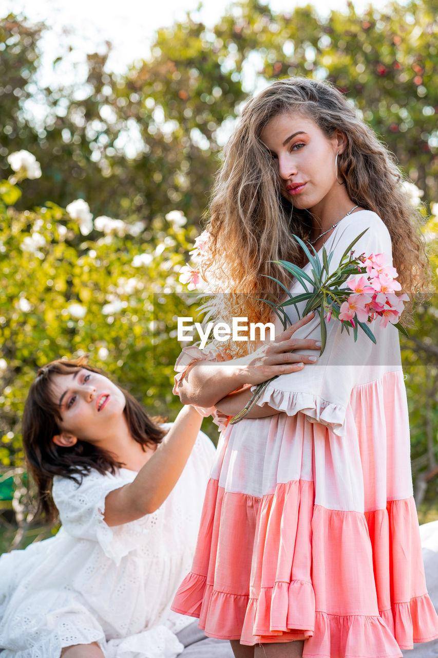 Beautiful women against plant outdoors