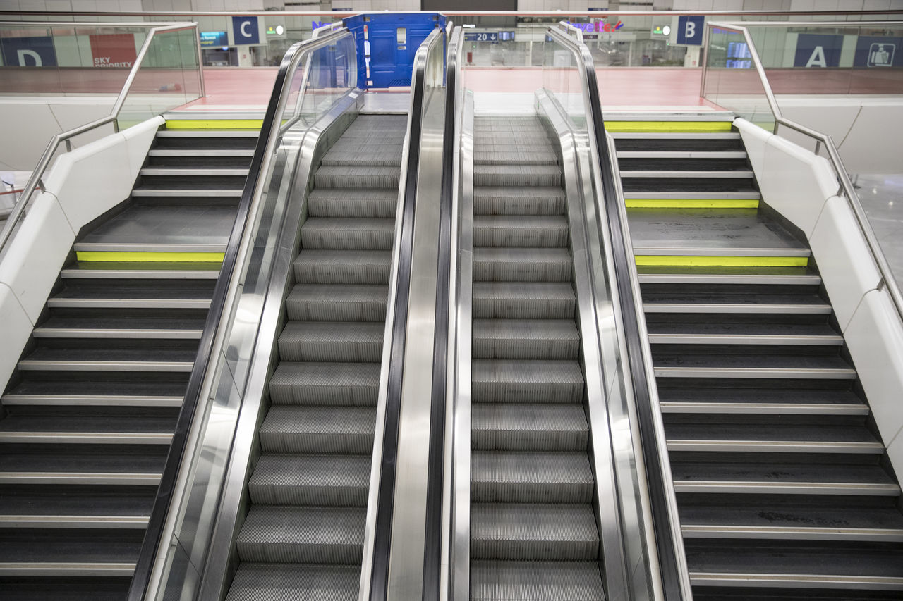 LOW ANGLE VIEW OF ESCALATOR IN OFFICE