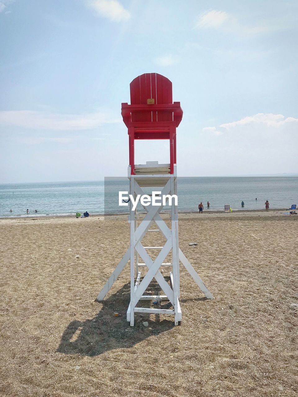 Lifeguard chair at beach against sky