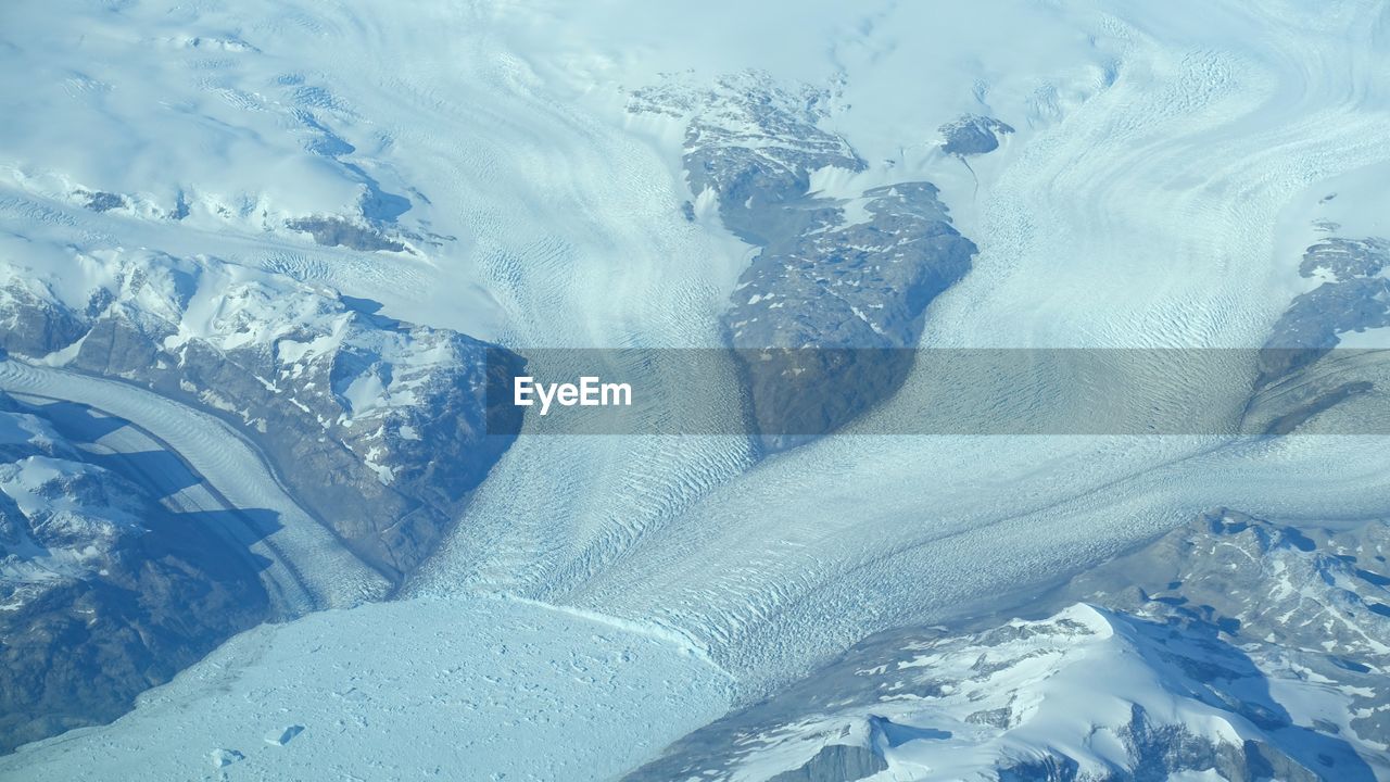 HIGH ANGLE VIEW OF SNOW COVERED LANDSCAPE