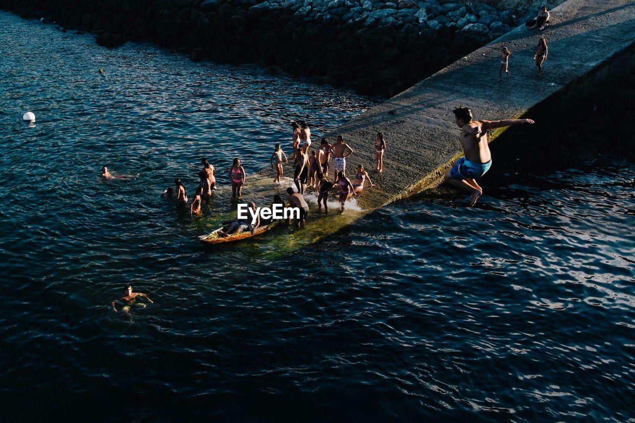 High angle view of people enjoying in lake