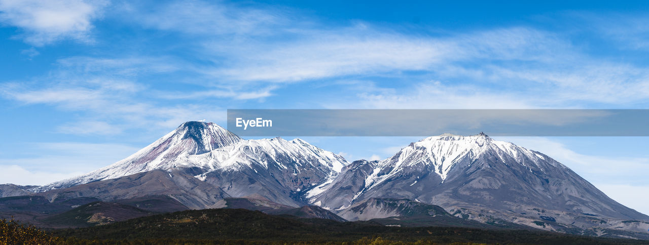 SCENIC VIEW OF MOUNTAINS AGAINST BLUE SKY