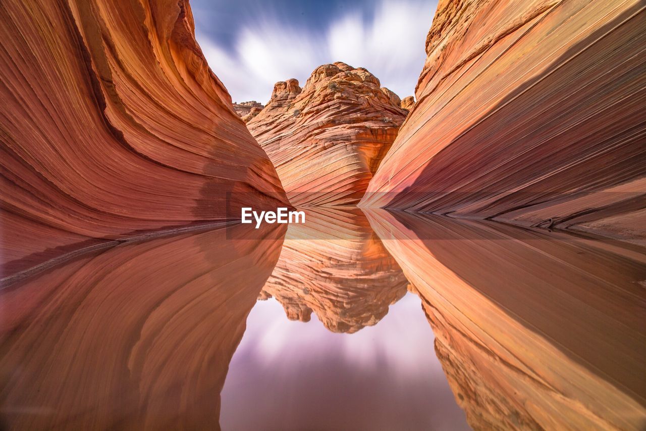Rock formations reflecting on calm lake at coyote buttes