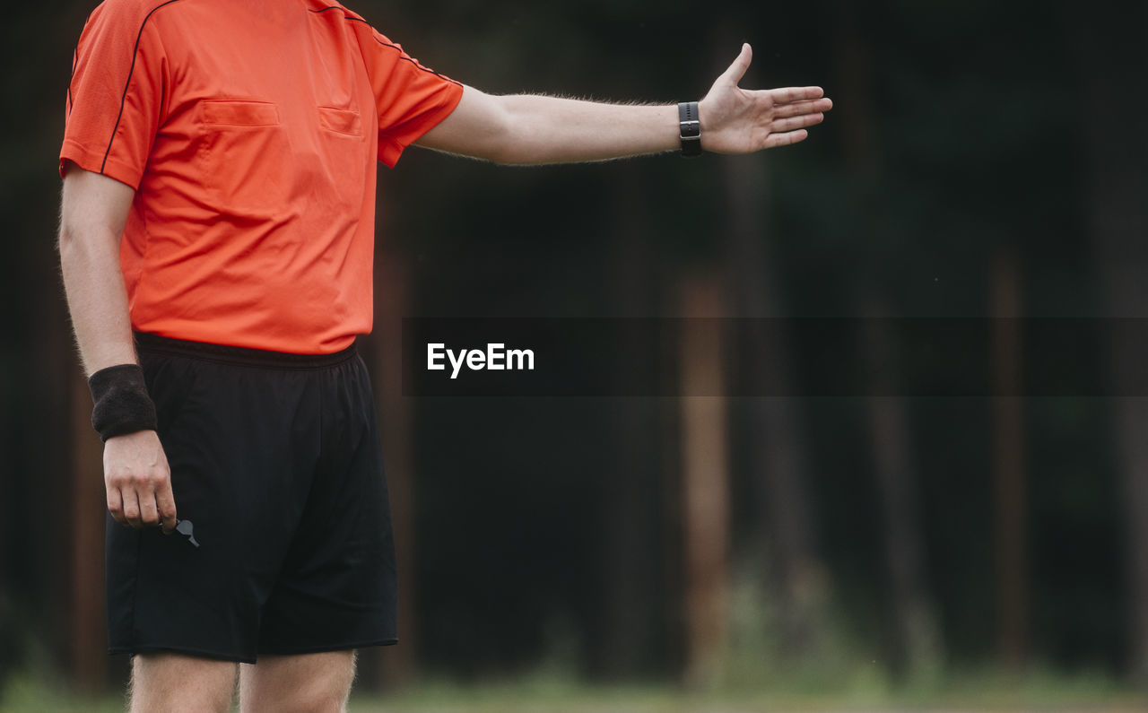 Midsection of man standing in park