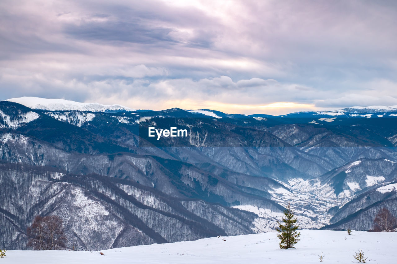 Scenic view of snowcapped mountains against sky