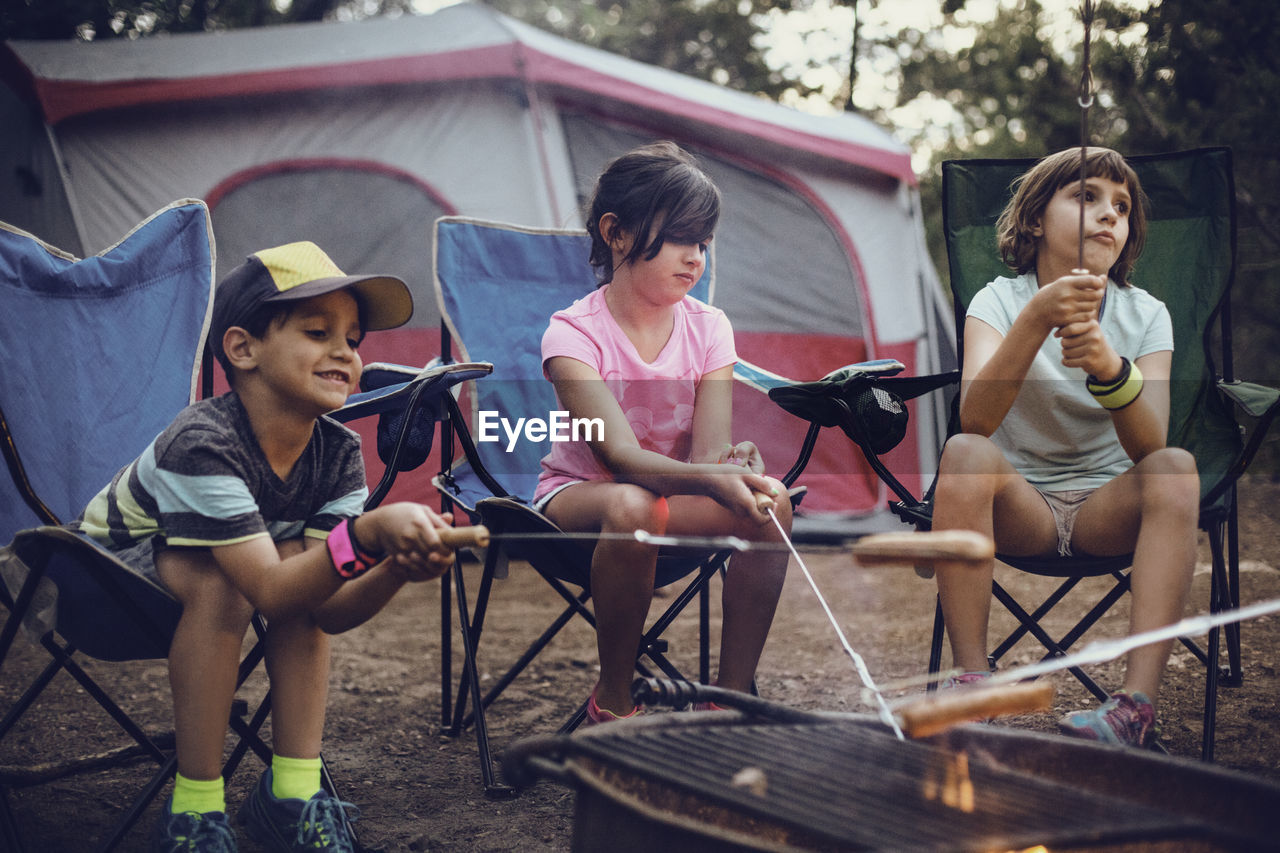 Siblings barbecuing in forest