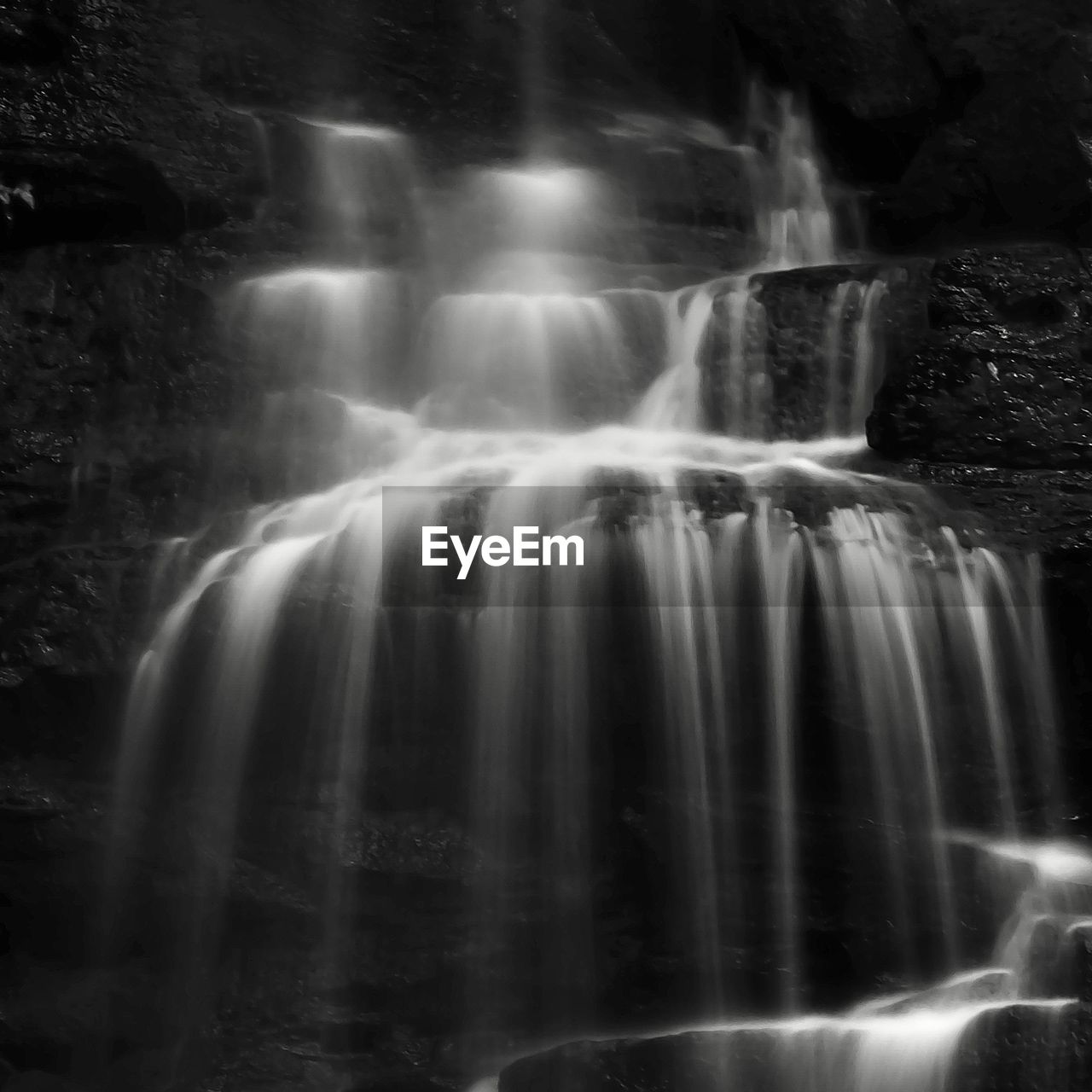 waterfall, water, scenics - nature, motion, long exposure, water feature, beauty in nature, black and white, monochrome photography, nature, darkness, blurred motion, monochrome, rock, environment, flowing, no people, flowing water, land, body of water, travel destinations, outdoors, forest, rock formation