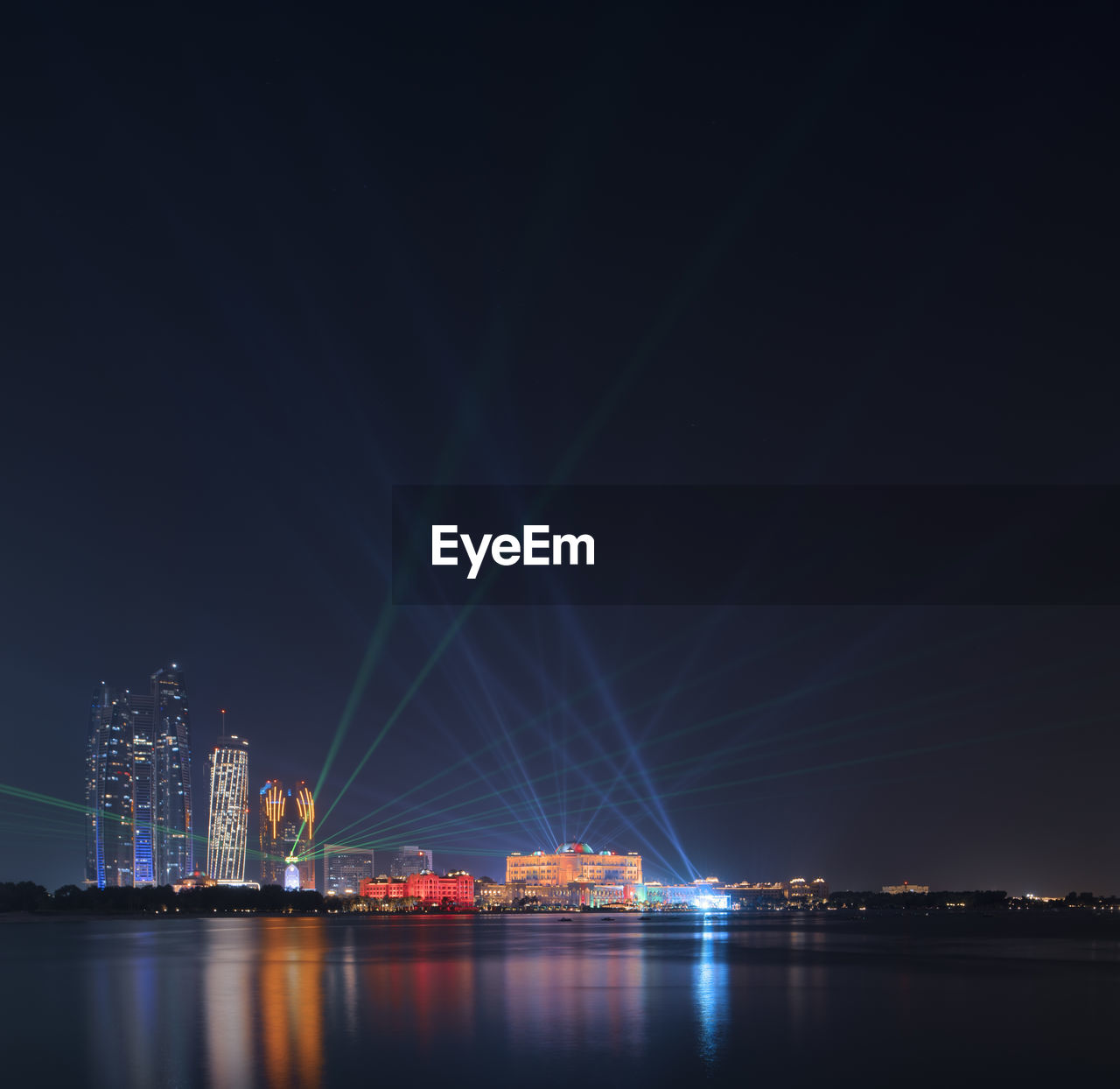 Laser beams over emirates palace in abu dhabi during uae 50th national day celebrations .