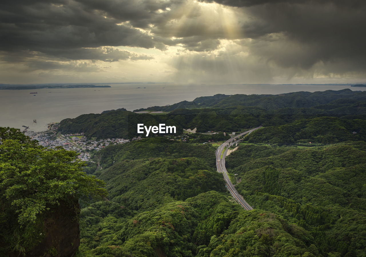 Sunlight filtering through a cloudy sky on the uraga channel and the futtsu-tateyama road.