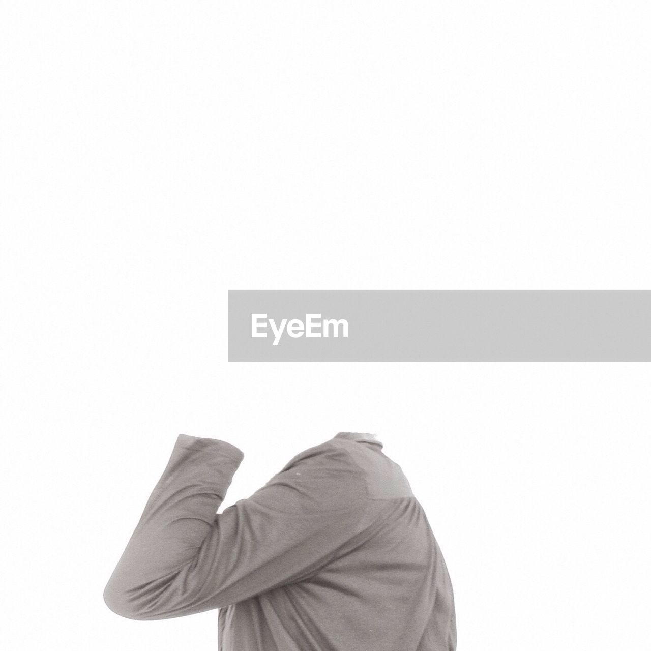 Headless mannequin wearing shirt against white background