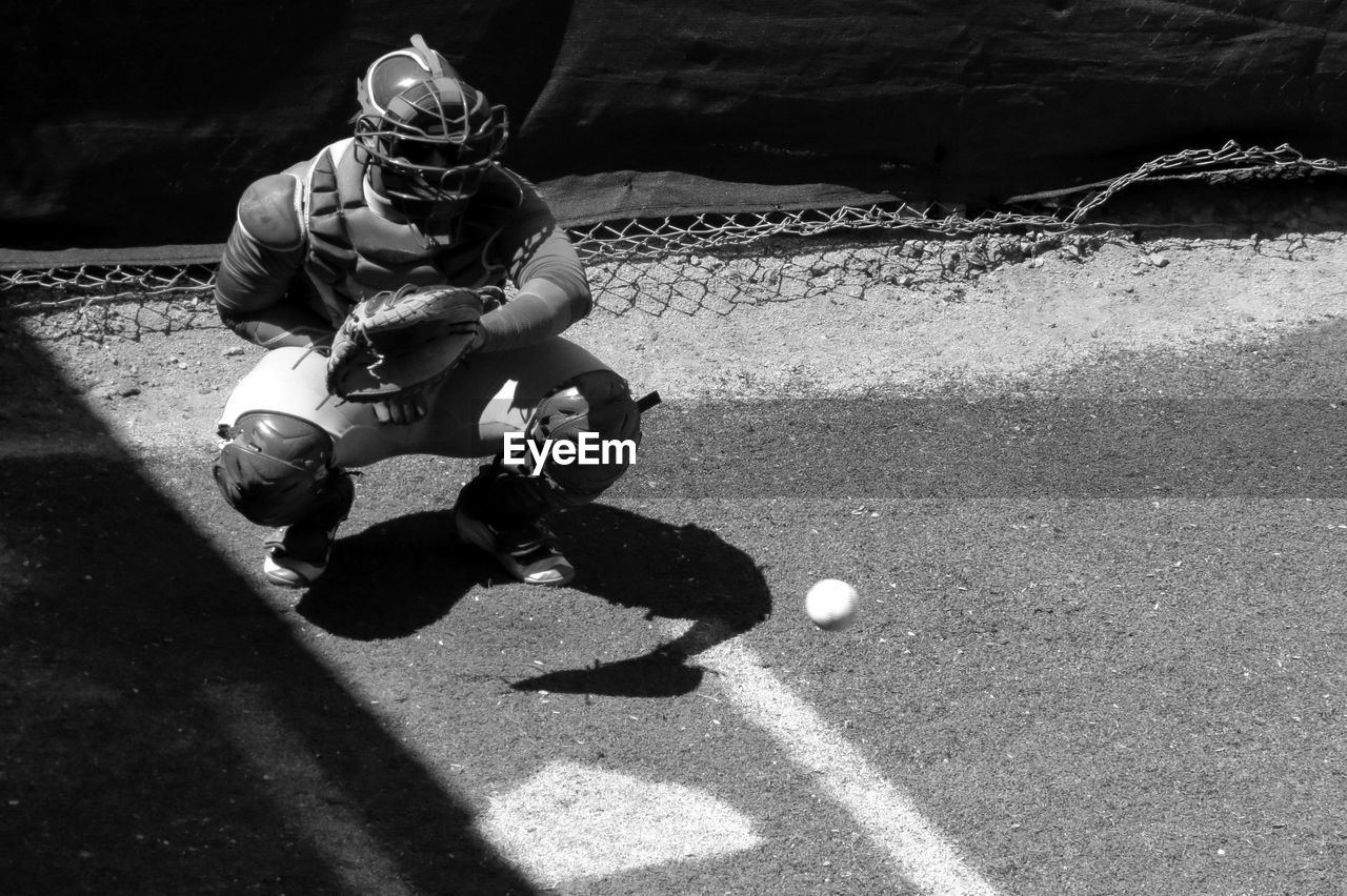 Ball moving towards baseball catcher