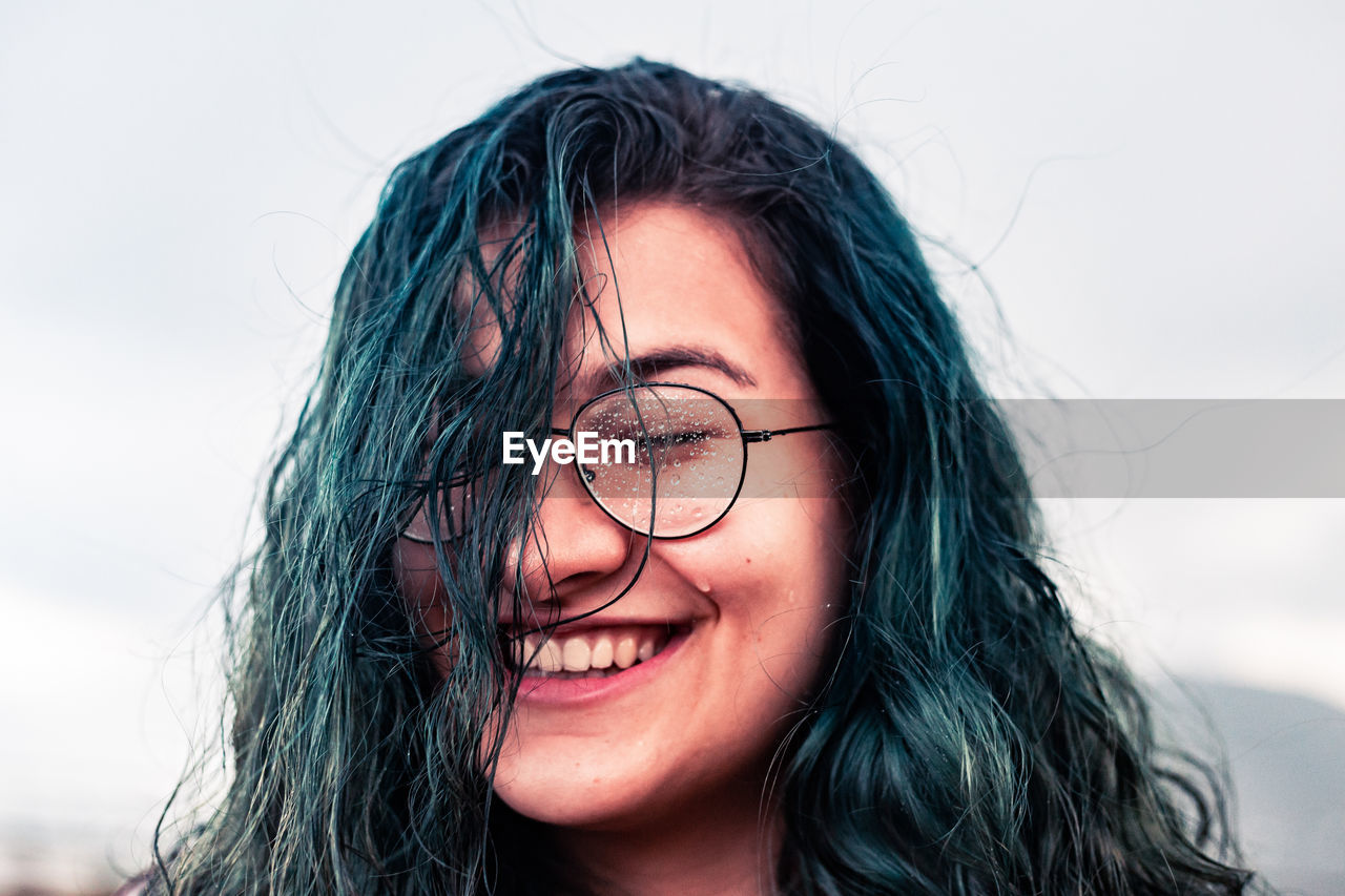Close-up of smiling young woman in eyeglasses