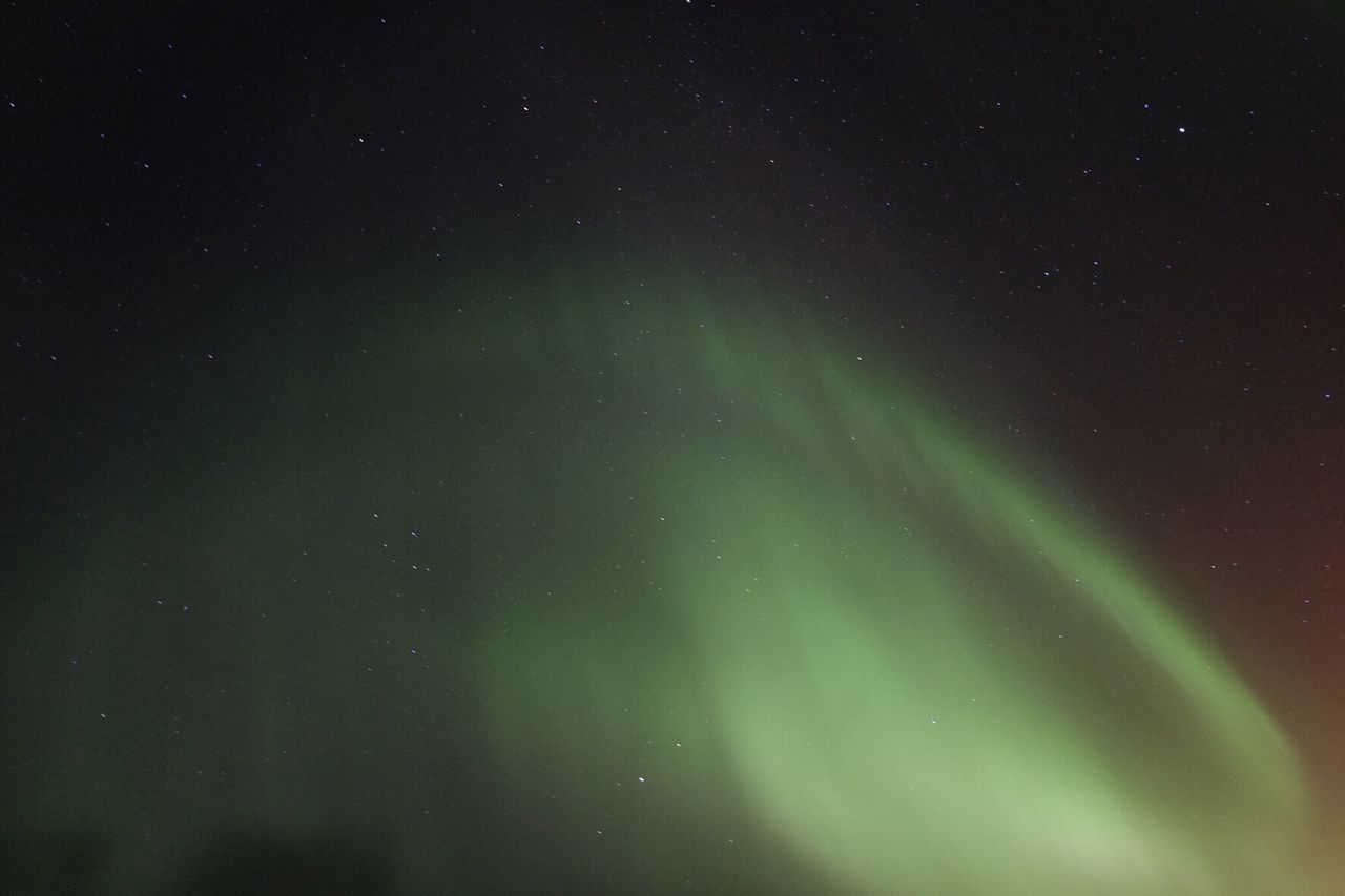Scenic view of aurora against star field