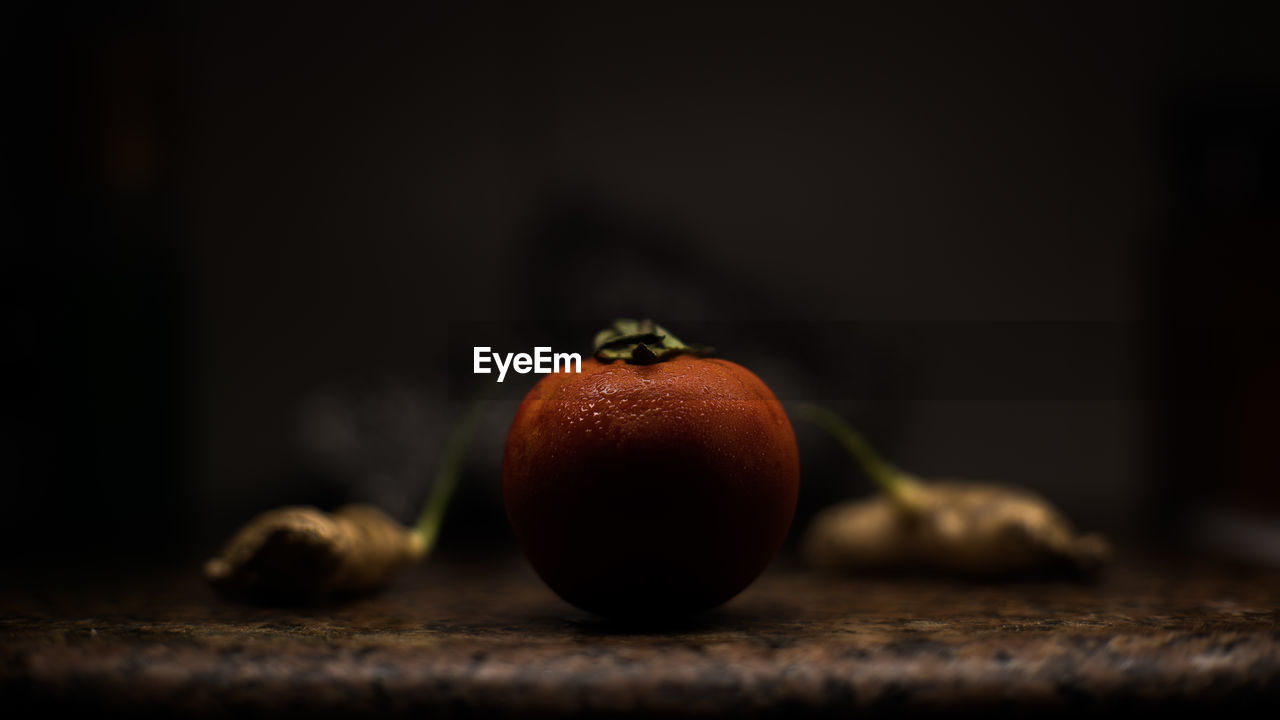 Close-up of tomato with gingers on kitchen counter at home