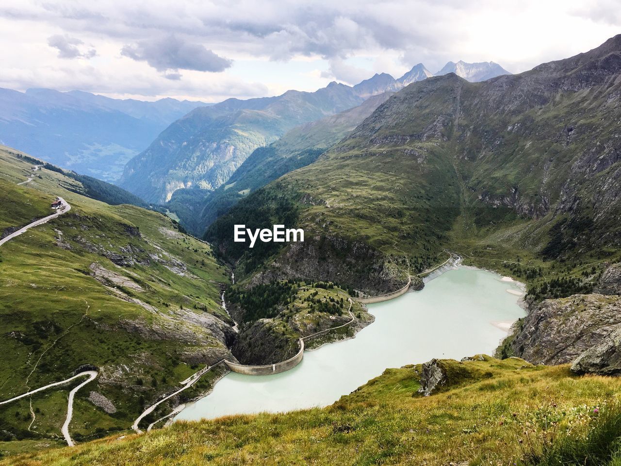 Scenic view of river amidst mountains against sky