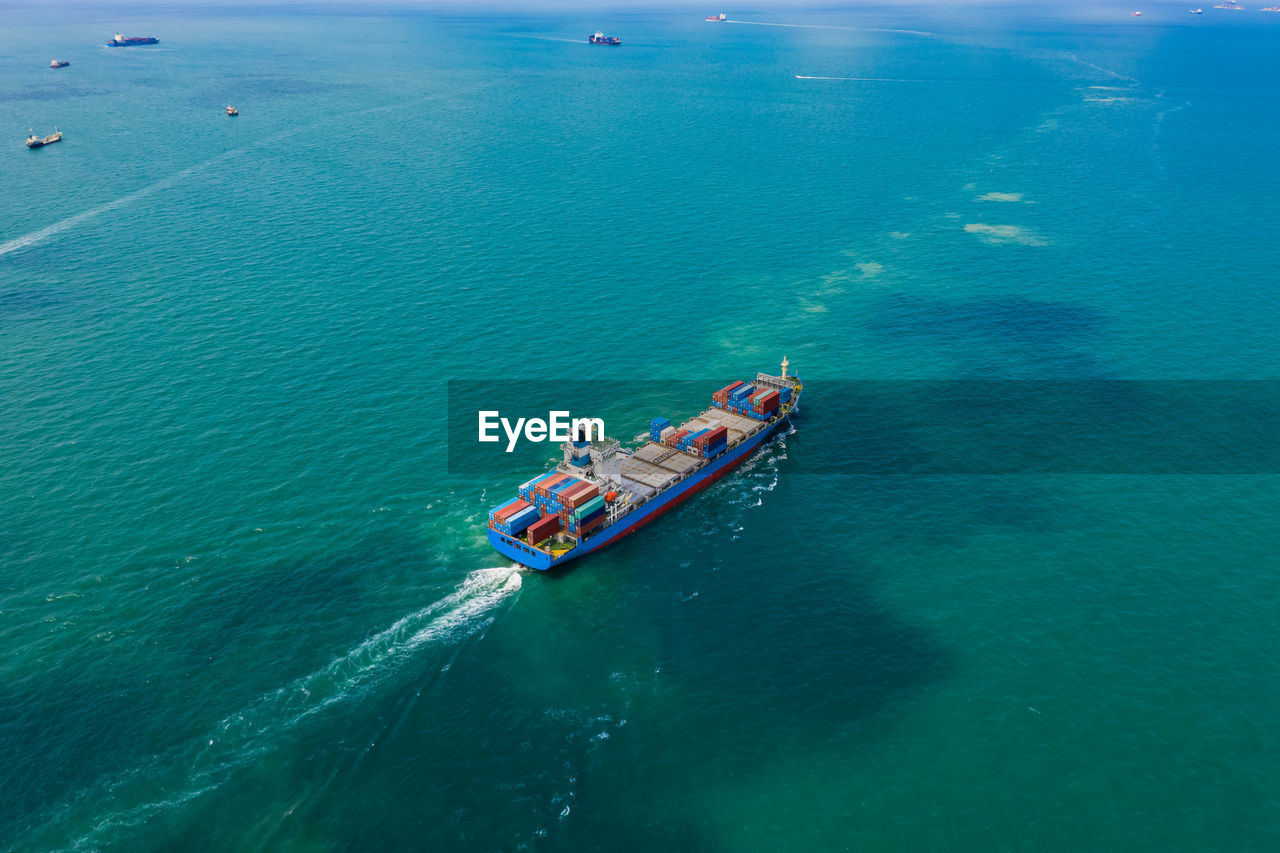 High angle view of shipping container sailing in sea