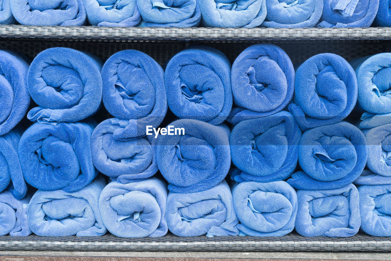 Full frame shot of rolled up towels in rack