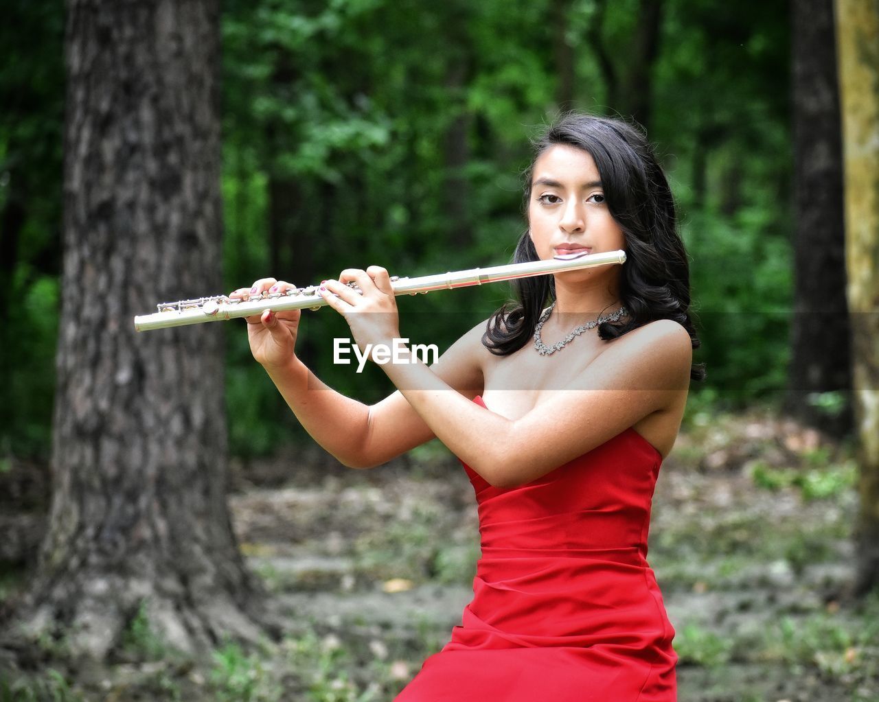 Young woman holding a flute 