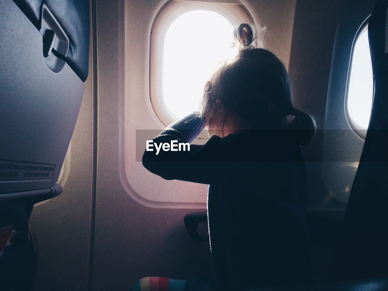 Girl sitting in airplane