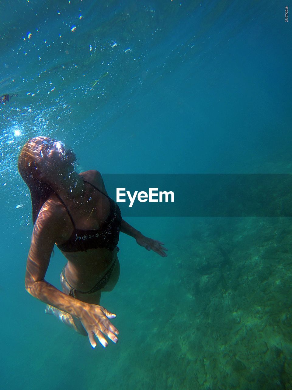 Young woman swimming undersea