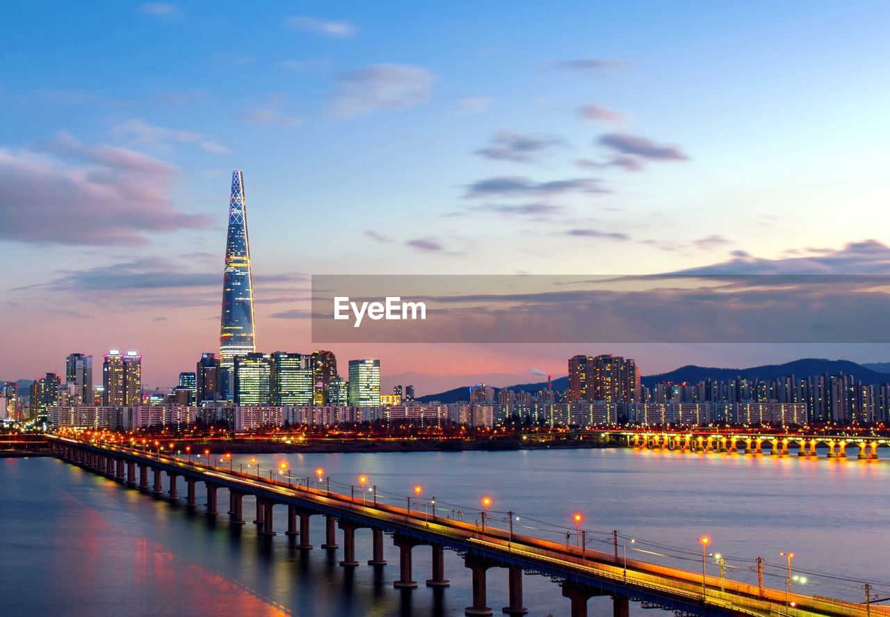 VIEW OF ILLUMINATED BUILDINGS AT SUNSET