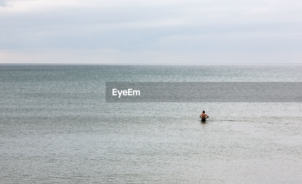 MAN FISHING IN SEA