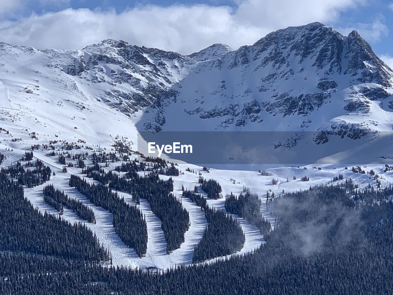 Snowcapped seven heaven mountains against sky on whistler blackcomb ski resort