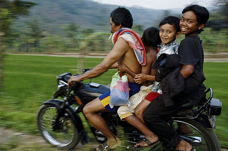 Family of four riding on motorcycle