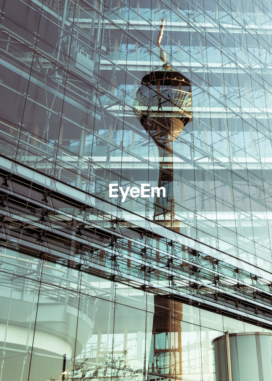 LOW ANGLE VIEW OF MODERN BUILDING WITH REFLECTION