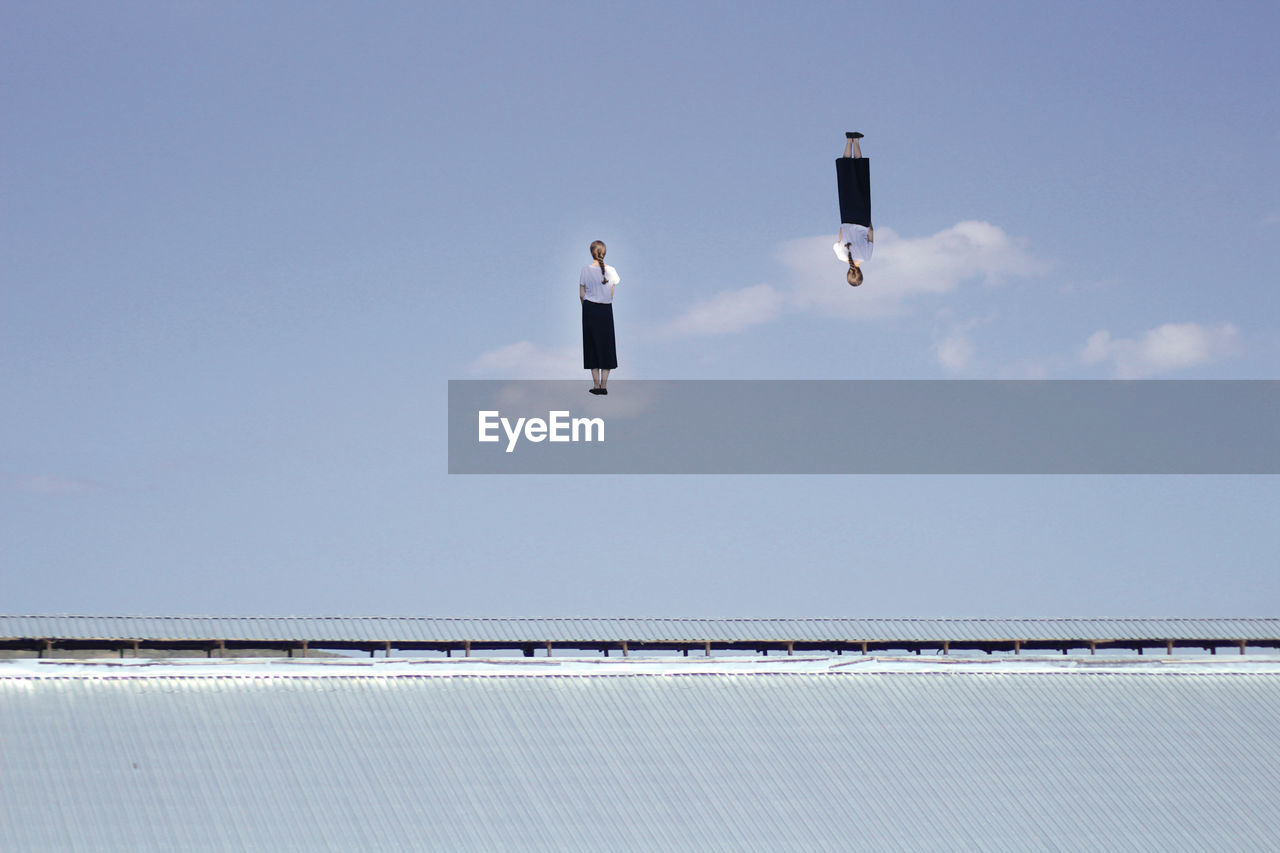 Digital composite image of woman standing in mid-air over roof