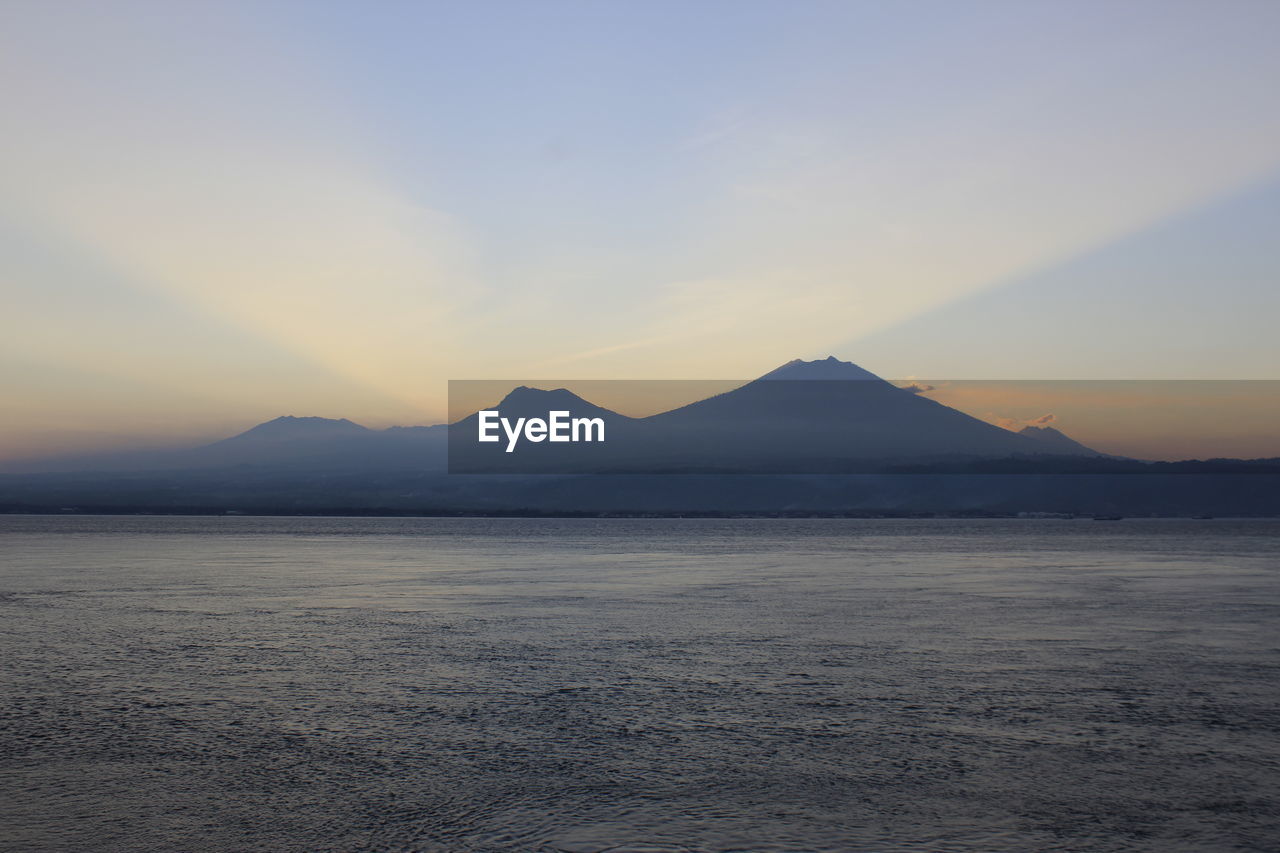 SCENIC VIEW OF MOUNTAINS AGAINST SKY AT SUNSET