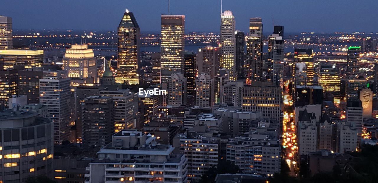 Aerial view of illuminated buildings in city at night