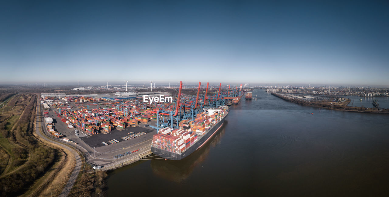 Large panorama of the port of hamburg with container terminal in sunny weather