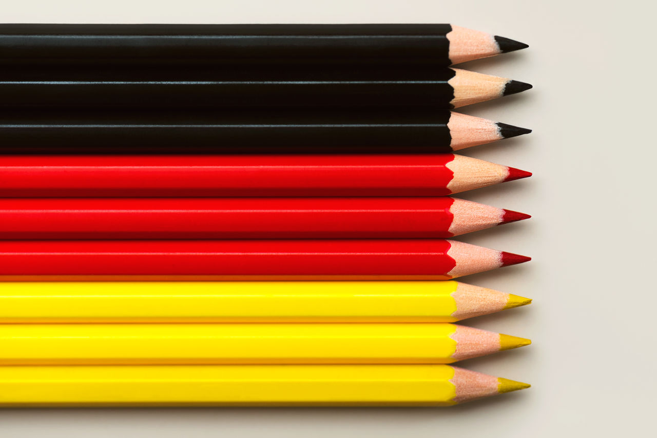 high angle view of colored pencils against white background
