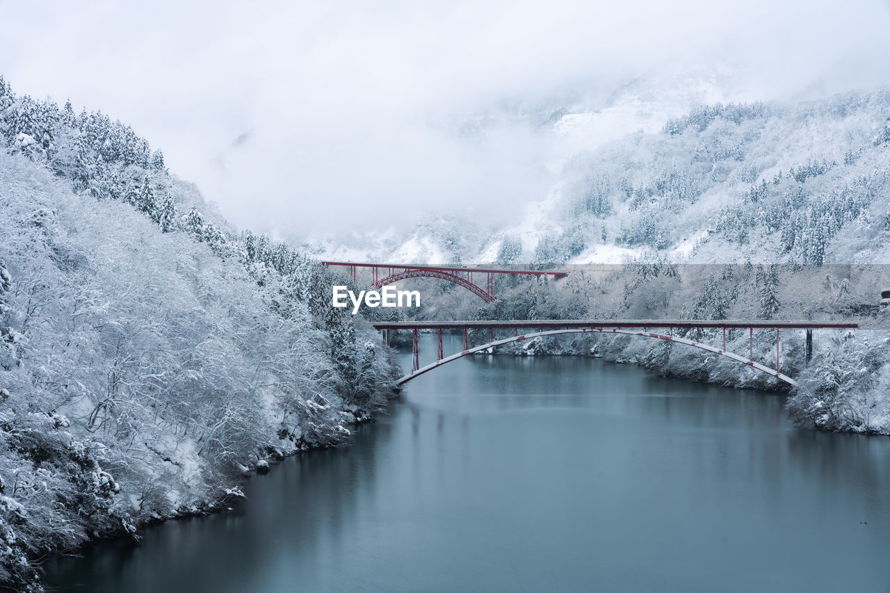 Bridge over river during winter